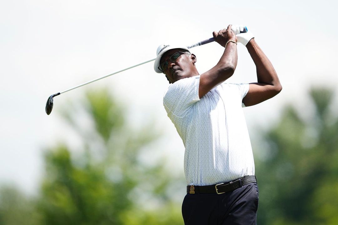 Golfer Holding Golf Club and a Louis Vuitton Bag