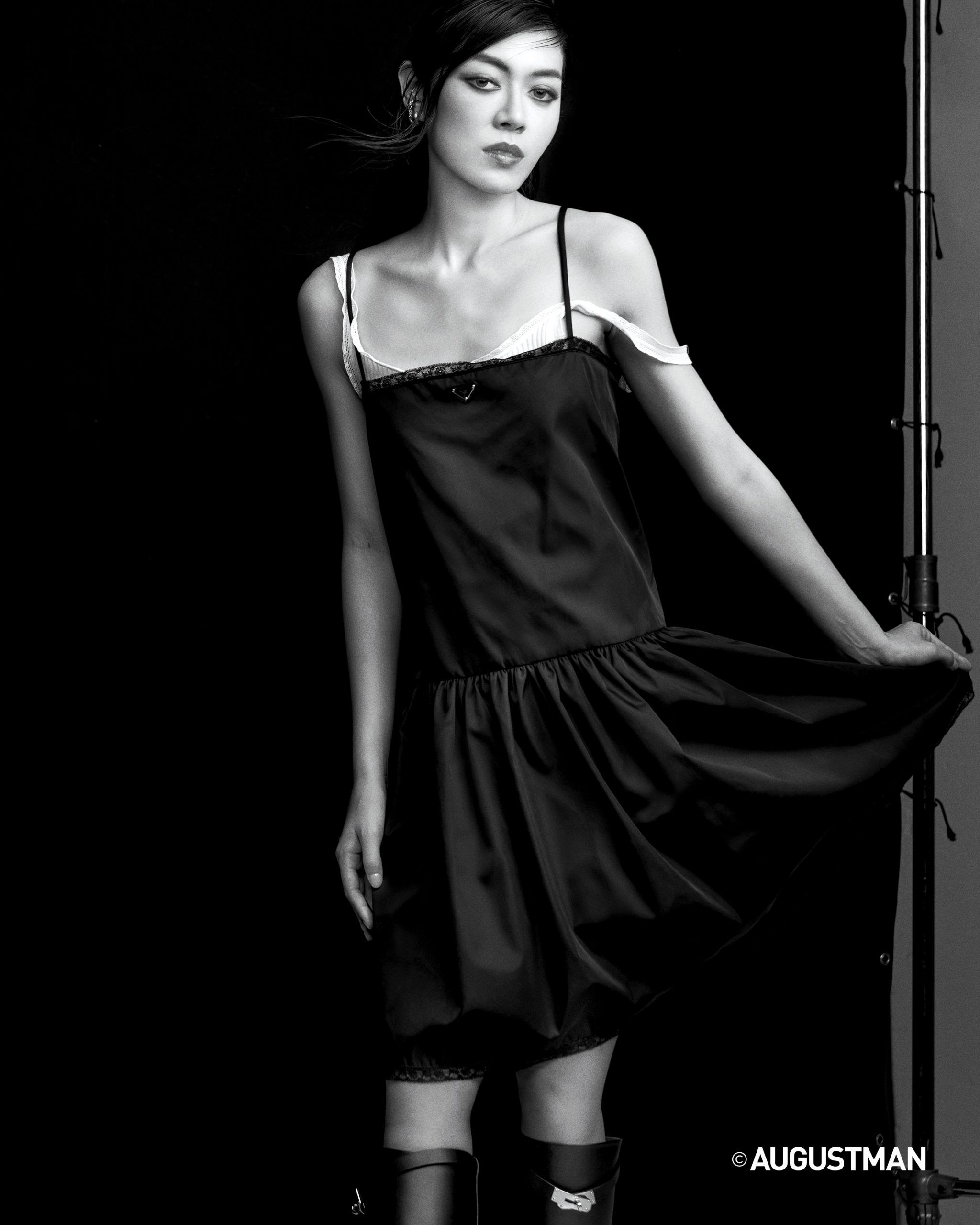 Jasmine Sokko is wearing a nylon dress and tank top from Prada, and leather boots and Etriviere earrings with diamonds
in 18k white gold from Hermès.